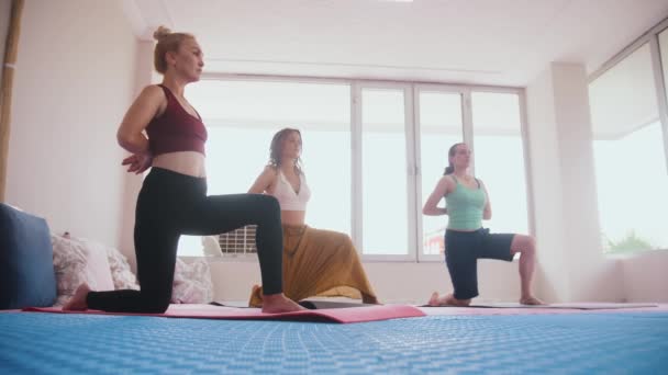 Three Women Standing Yoga Mats Knees Does Practice Mid Shot — Video