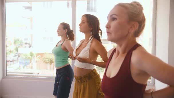 Three Women Having Yoga Classes Studio Running Hands Chest Mid — Vídeo de Stock