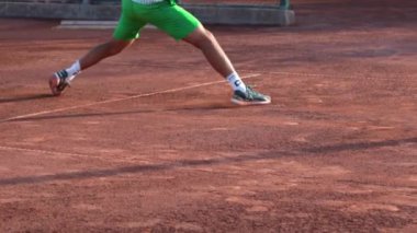 24-05-2022 TURKEY, ANTALYA: A young man runs around the court and brakes with his shoes. Mid shot