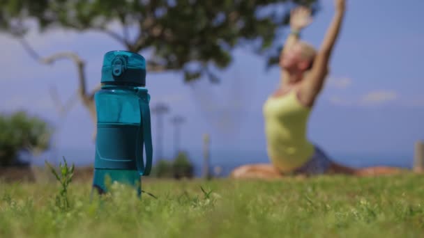 Bottle Water Standing Ground Woman Doing Yoga Nature Picking Bottle — Vídeos de Stock
