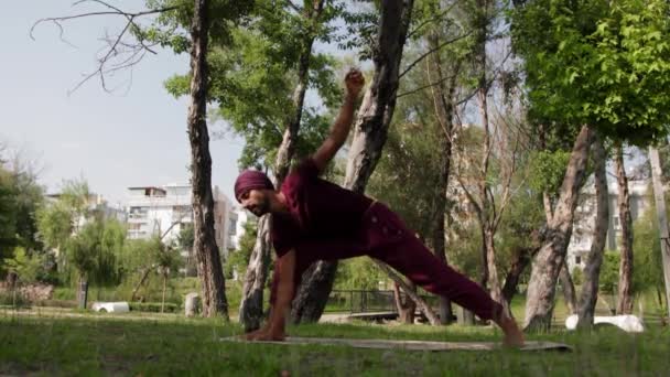 Arabian Man Doing Stretching Yoga Exercises Park Mid Shot — стоковое видео