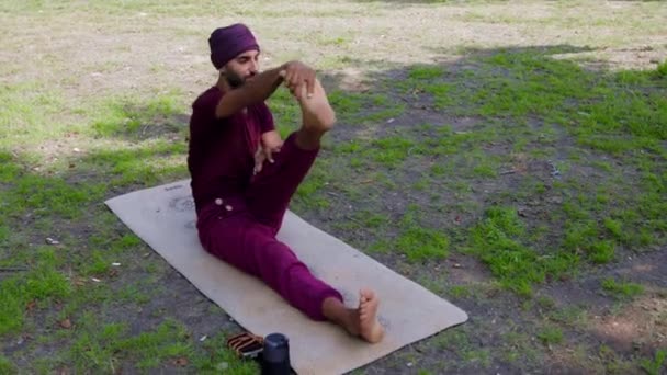 Arabian Man Doing Yoga Outdoors Holding His Foot Talking His — Vídeos de Stock