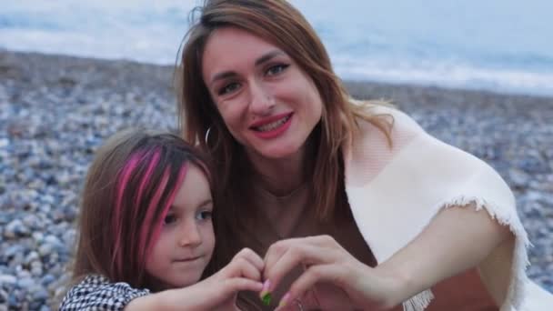 Little Girl Pink Strands Showing Finger Heart Her Smiling Mother — Stockvideo