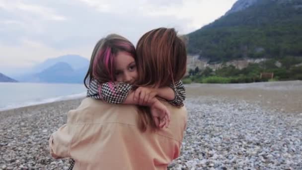 Cute Little Girl Pink Strands Hugging Her Mother Pebble Beach — стоковое видео
