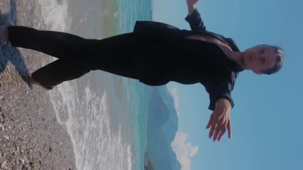Приваблива Людина Чорному Одязі Танцює Голими Ногами Березі Моря Середній — стокове відео