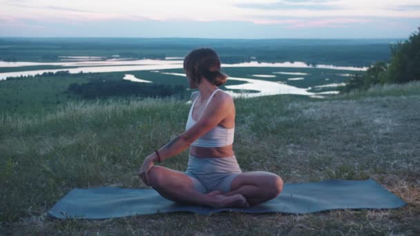 Mujer Adulta Delgada Sentada Una Esterilla Yoga Colina Atardecer Calentando — Vídeo de stock