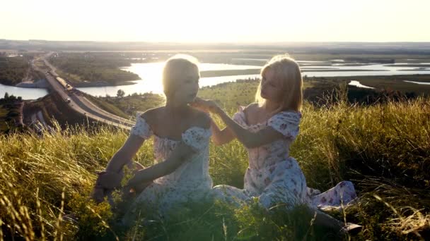 Two Blonde Young Women Light Summer Dresses Sitting Hill Highway — Stock Video