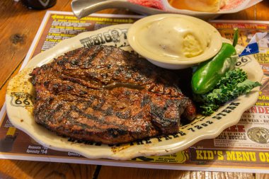 Amarillo, Texas, United States of America - January 1, 2017. Steak at Big Texan Steak Ranch in Amarillo, TX. clipart