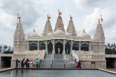 Houston, Texas, United States of America - January 16, 2017. Exterior view of Hindu temple BAPS Shri Swaminarayan Mandir in Houston, TX, with people. clipart