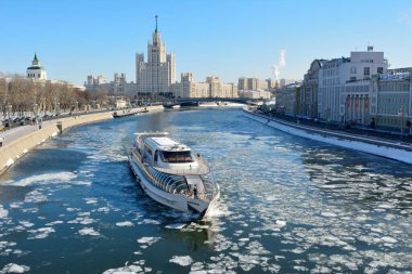 Moskova, Rusya - 18 Mart 2018. Moskova Nehri 'nin üzerinden Kotelnicheskaya Embankment binasına doğru seyir gemisi, tarihi binalar, şehir trafiği ve insanlarla birlikte bakın..