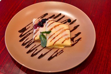 Pancake with curd and blueberry jam in Russia.