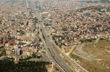 Pendik, Istanbul, Turkey - September 9, 2018. Aerial view over Pendik suburb of Istanbul and highway D100 with commercial and residential properties and traffic.