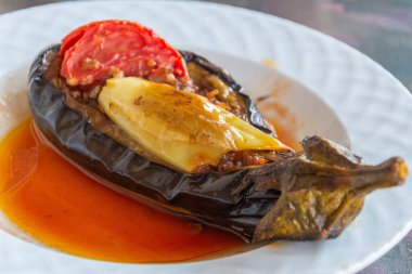 Imam bayildi dish in Turkey. Braised aubergine stuffed with garlic, onion and tomatoes.