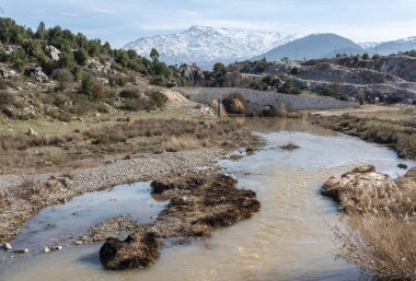 View over Xanthos river toward historic Ottoman bridge near Fethiye town in Turkey.