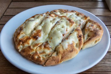 Turkish flat pita bread covered with cheese.