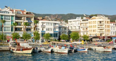 Marmaris, Turkey - July 23, 2016. Waterfront in Marmaris resort town, with residential and commercial properties, boats and people.
