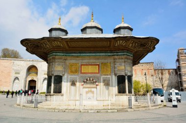 Istanbul, Turkey - April 23, 2017. The Fountain of Sultan Ahmed III, located in front of the Imperial Gate of Topkapi Palace in Istanbul, with people.