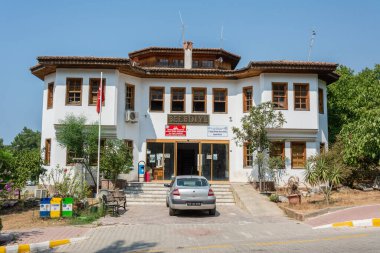 Akyaka, Mugla, Turkey - July 30, 2016. Building housing the belediye municipal administration of Akyaka village in Mugla province of Turkey, with car.