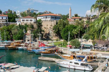 Antalya, Turkey - August 31, 2016. View over the harbour and historic district Kaleici in Antalya, Turkey, with boats, people and historic buildings.