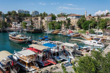 Antalya, Turkey - August 31, 2016. View over the harbour and historic district Kaleici in Antalya, Turkey, with boats, people and historic buildings.