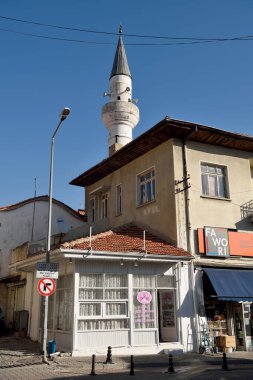 Mugla, Turkey - November 7, 2018. Street view in Mugla city, Turkey, with residential buildings, commercial properties and minaret of Seyh cami mosque. 