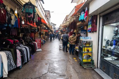 Izmir, Turkey - January 26, 2019. View of Havra Sokak street in Kemeralti market in Izmir, with shops and people.