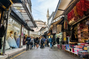 Izmir, Turkey - January 26, 2019. Street view in Kemeralti market in Izmir, with shops and people, toward Sadirvan mosque.