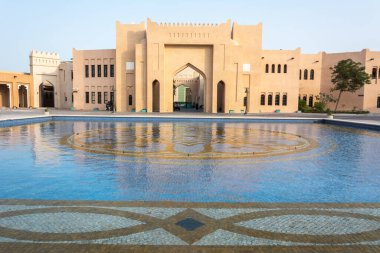 Doha, Qatar - November 7, 2016. Exterior view of Katara Hall in Katara cultural village in Doha, Qatar, across pool.