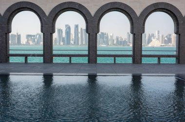 Doha, Qatar - November 9, 2016. Doha skyline viewed through the arches of the Museum of Islamic Art in Doha.