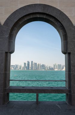 Doha, Qatar - November 9, 2016. Doha skyline viewed through the arches of the Museum of Islamic Art in Doha.