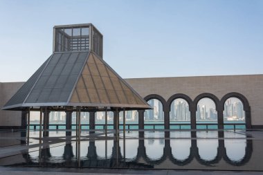 Doha, Qatar - November 9, 2016. Courtyard of the Museum of Islamic Art in Doha, with water and arches offering view to the Doha skyline.