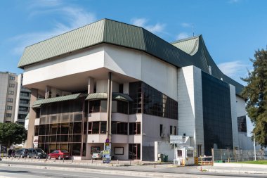 Izmir, Turkey - March 2, 2019. Exterior view of Ataturk Cultural Center (Ataturk Kultur Merkezi) in Izmir, with cars and people.