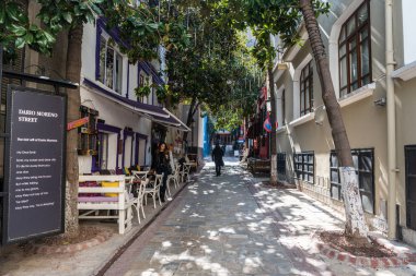 Izmir, Turkey - March 2, 2019. View of Dario Moreno street leading up to Asansor elevator in Izmir, with people and commercial properties. 