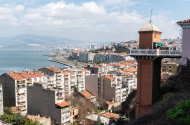 Izmir, Turkey - March 2, 2019. View of Asansor elevator and Konak district of Izmir, with residential buildings and people. 