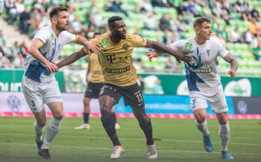 Budapest, Hungary - May 4, 2022. Ferencvaros midfielder Anderson Esiti against Zalaegerszeg players Kalnoki Kis David and Daniel Zsori during Hungarian OTP Bank Liga Gameweek 31 match Ferencvaros vs Zalaegerszegi (5-3)