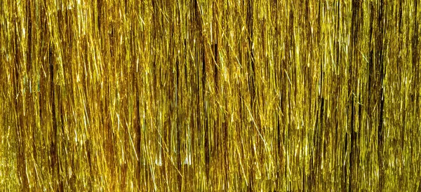 Metallic gold foil tinsel fringe decoration curtain. Birthday, wedding, Christmas, New Year party decoration background — Stock Photo, Image