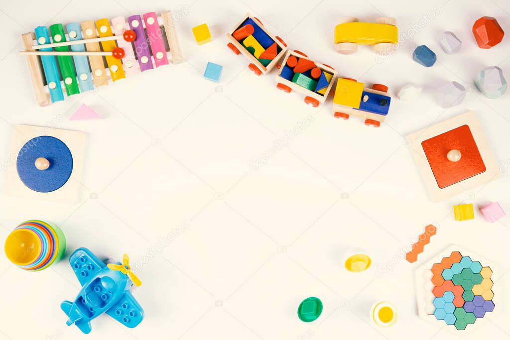 Colorful educational and musical toys for baby kids on white background. Top view, flat lay