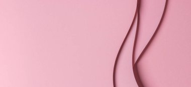 Soyut renkli kağıt geometri kompozisyonu, tek renkli arkaplan, kıvrımlı çizgiler ve pembe renkte.
