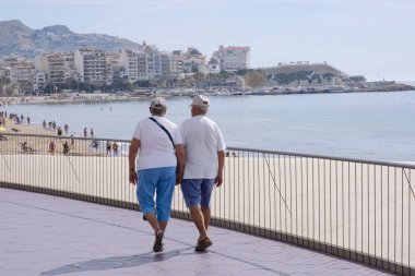 Benidorm, İspanya, 12 Mart 2020. Benidorm, Alicante, İspanya 'da güneşli bir günün tadını çıkaran turistler