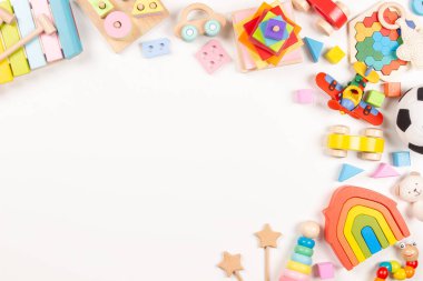 Bebek oyuncakları beyaz arka planda çerçevelenmiş. Bir sürü renkli Montessori eğitici tahta oyuncaklar. Üst görünüm, düz görünüm, metin için alanı kopyala