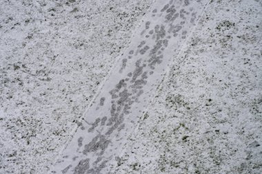Kışın caddelerin ve kaldırımların bakımı. Hafif karlı kaldırım ve yaya yolunda insan ayak izleri. Hava görünümü