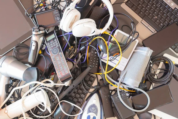 Top view to old computers, digital tablets, mobile phones, many used electronic gadgets devices, broken household and appliances. Planned obsolescence, electronic waste for recycling concept