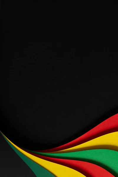 Abstract geometric black, red, yellow, green color paper background. Black History Month color background with copy space for text — Foto Stock