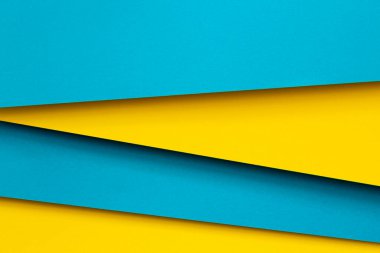 Soyut renk kağıtları geometri düz kompozisyon arka planı mavi ve sarı tonlarla