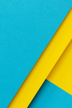 Soyut renk kağıtları geometri düz kompozisyon arkaplan mavi ve sarı tonlu. Üst görünüm