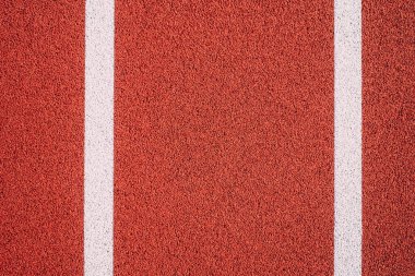 Renkli bir spor salonu geçmişi var. Üst görüntüden kırmızı alana lastik zemin ve beyaz çizgiler açık havaya.