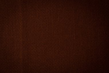 Kahverengi renk, tekstil kumaş kumaş dokusu arkaplanı. Soyut tek renkli koyu kahverengi keçeli arka plan.