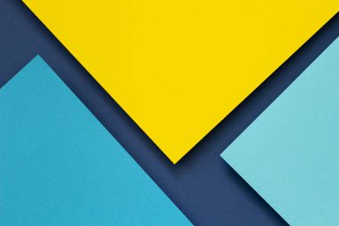 Soyut renk kağıtları geometri düz kompozisyon arkaplan mavi ve sarı tonlu. Üst görünüm.