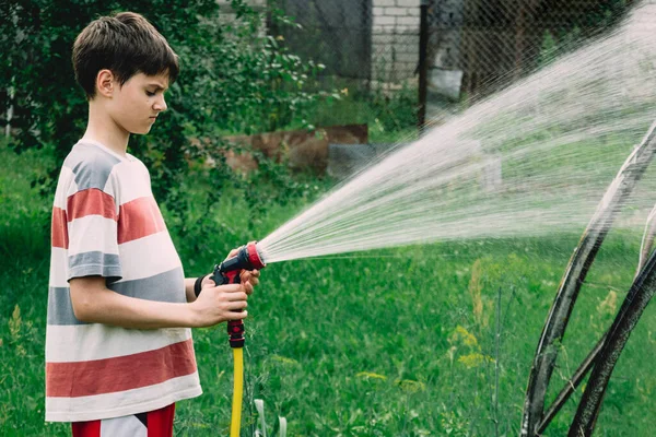 Teenager Watering Plants Garden Kid Water Hose Gardening Outdoor Countryside — Foto Stock