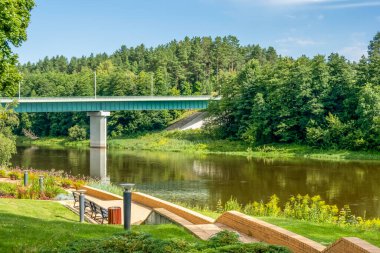 View to Nemunas river with bridge and embankment in Druskininkai. Lithuania. Druskininkai is resort with health promotion, recreation, active lifestyle, exceptional entertainment.
